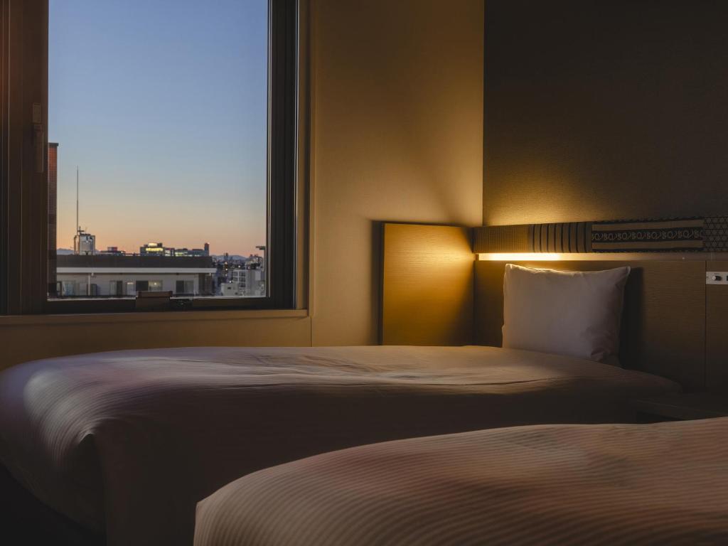 Postel nebo postele na pokoji v ubytování Hotel Gracery Asakusa