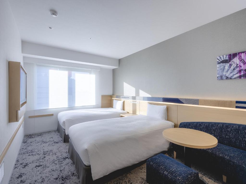 Postel nebo postele na pokoji v ubytování Hotel Gracery Asakusa