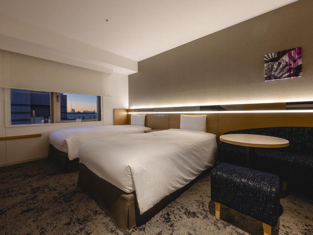 Postel nebo postele na pokoji v ubytování Hotel Gracery Asakusa