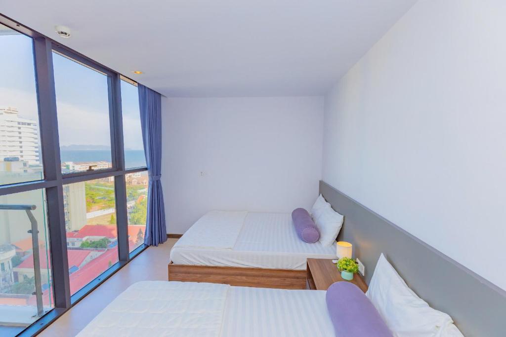 Postel nebo postele na pokoji v ubytování CSJ Seaside - Căn Hộ Cạnh Biển