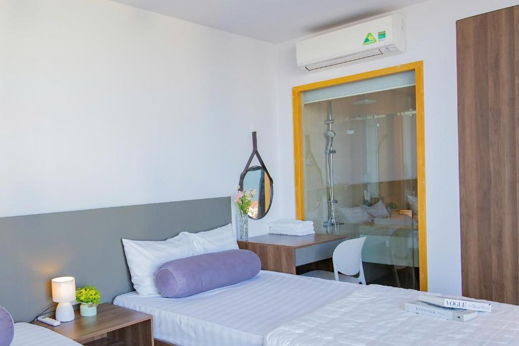 Postel nebo postele na pokoji v ubytování CSJ Seaside - Căn Hộ Cạnh Biển