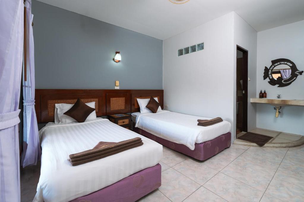 Postel nebo postele na pokoji v ubytování Asia Divers Resort