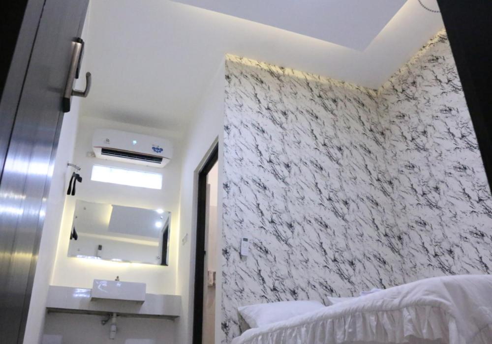Postel nebo postele na pokoji v ubytování Trion Homestay Syariah