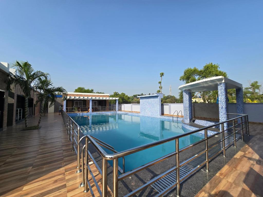 a swimming pool on the roof of a building at Sagar Kuthi in Mandarmoni
