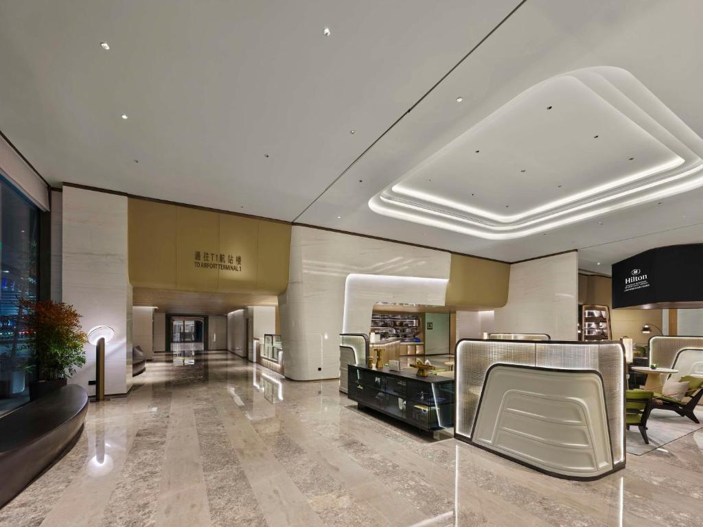 a lobby with chairs and a counter in a store at Hilton Shanghai Hongqiao International Airport in Shanghai