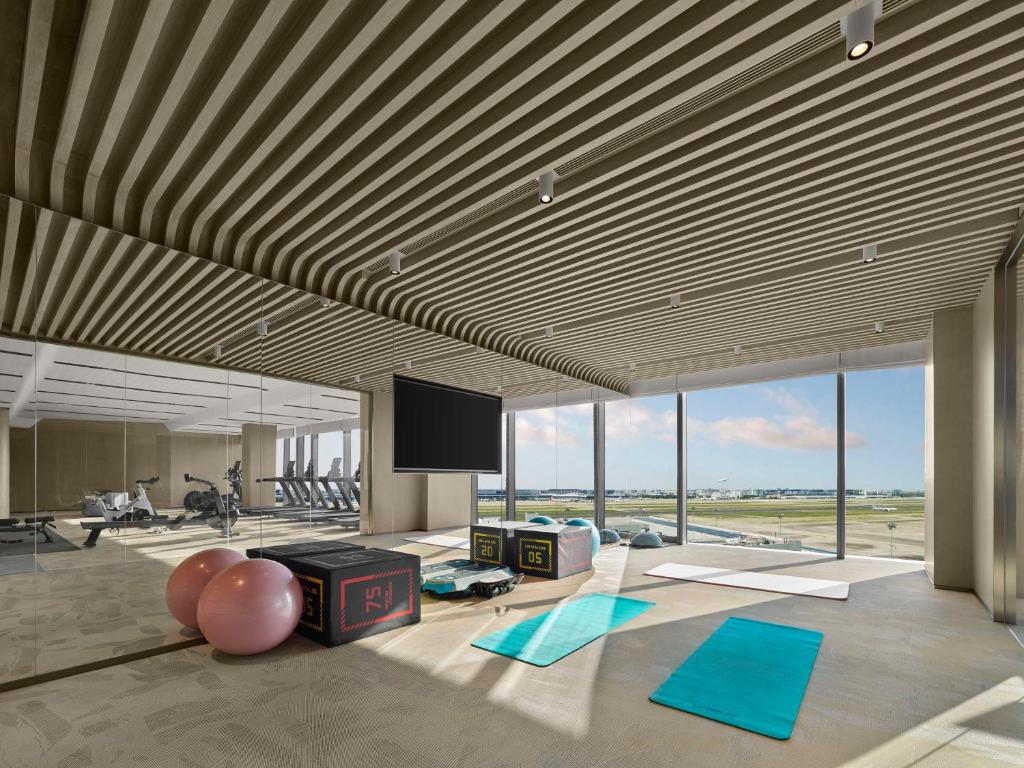 a large room with a television and yoga mats at Hilton Shanghai Hongqiao International Airport in Shanghai