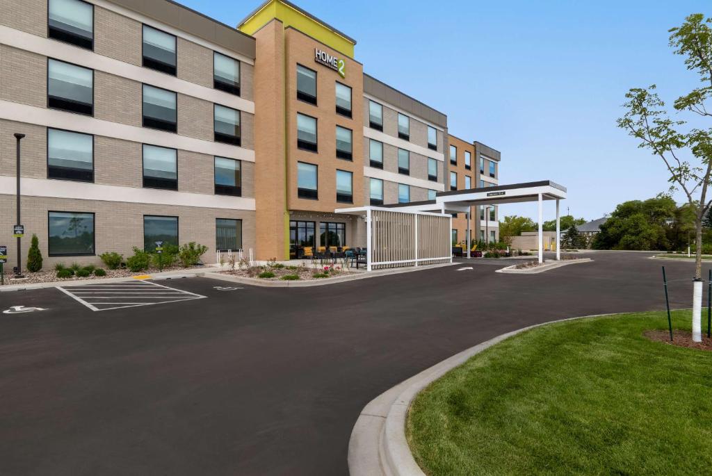 an empty parking lot in front of a building at Home2 Suites By Hilton Sheboygan in Sheboygan