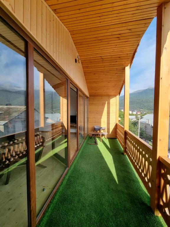 a balcony of a house with green grass at Guest house in Dilijan , whole apartment with 2 bedrooms in Dilijan