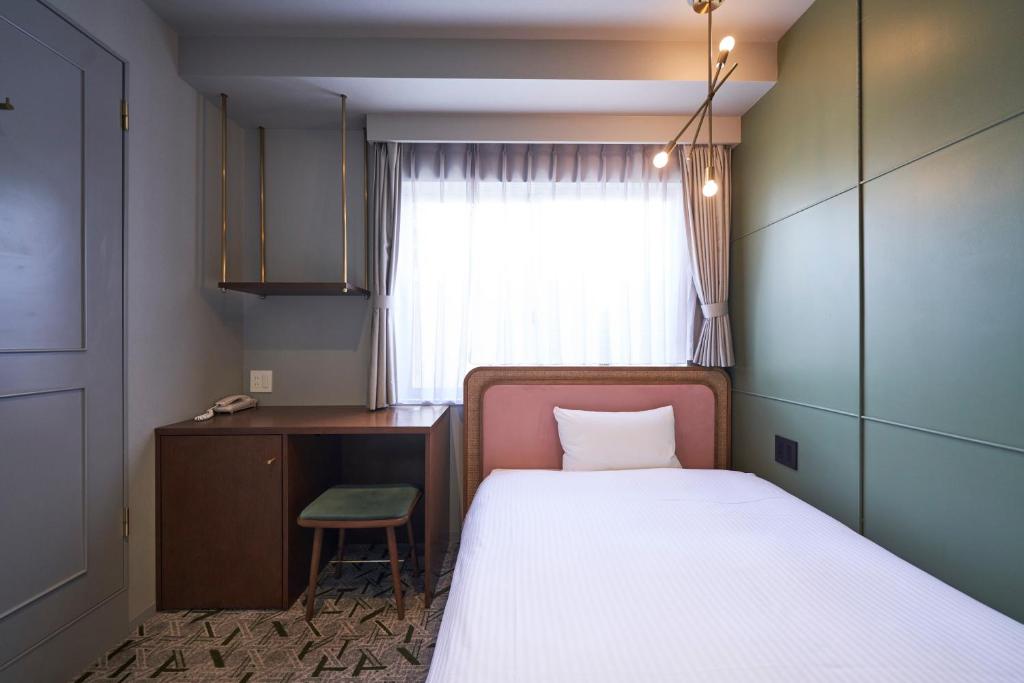 Postel nebo postele na pokoji v ubytování Mito Sannomaru Hotel