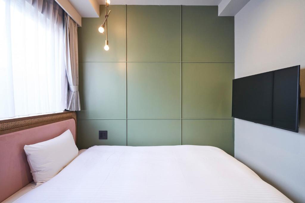 Postel nebo postele na pokoji v ubytování Mito Sannomaru Hotel