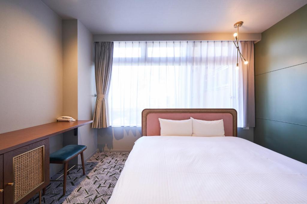 Postel nebo postele na pokoji v ubytování Mito Sannomaru Hotel