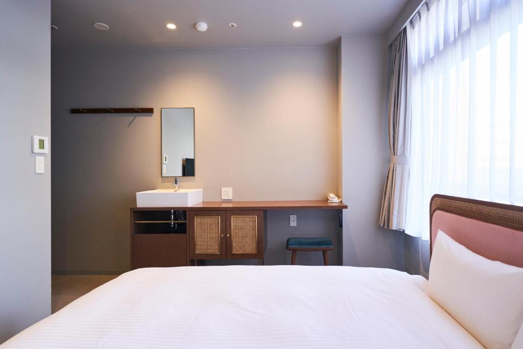 Postel nebo postele na pokoji v ubytování Mito Sannomaru Hotel