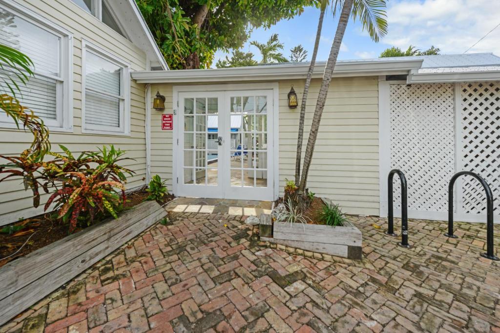a front door of a house with a palm tree at Colony Poolside in Key West