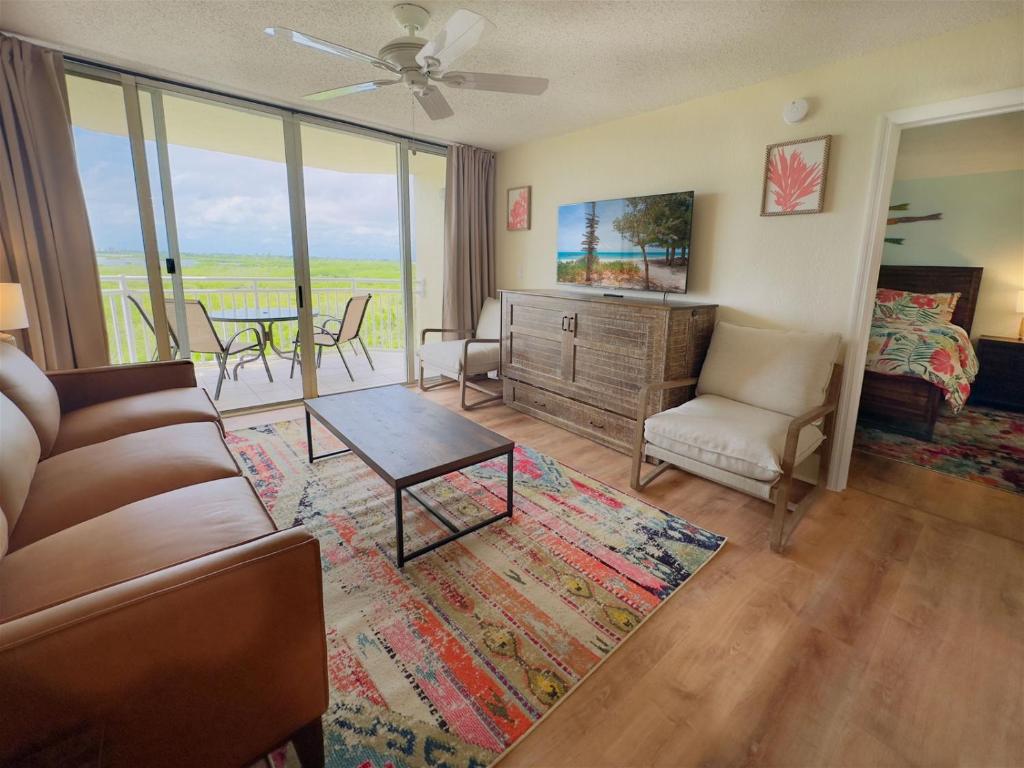 a living room with a couch and a table at Rum Cay Sunrise Suites in Key West