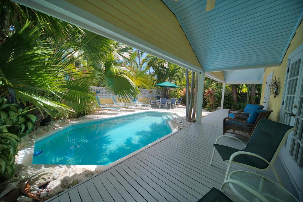 a porch with a swimming pool on a house at South St Cottage in Key West