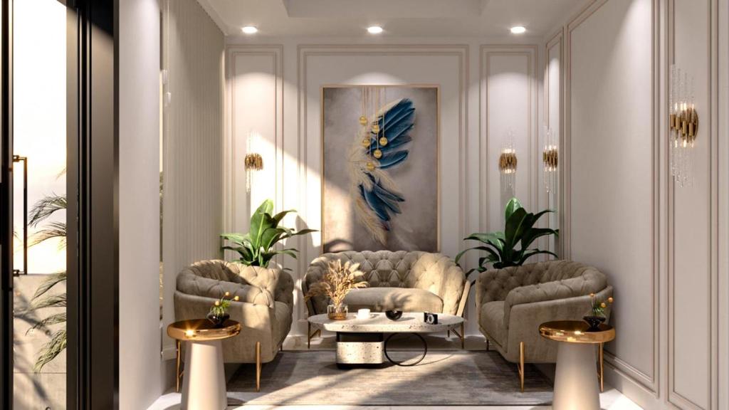 a lobby with chairs and a table in a room at Taj Comfort Inn in Agra