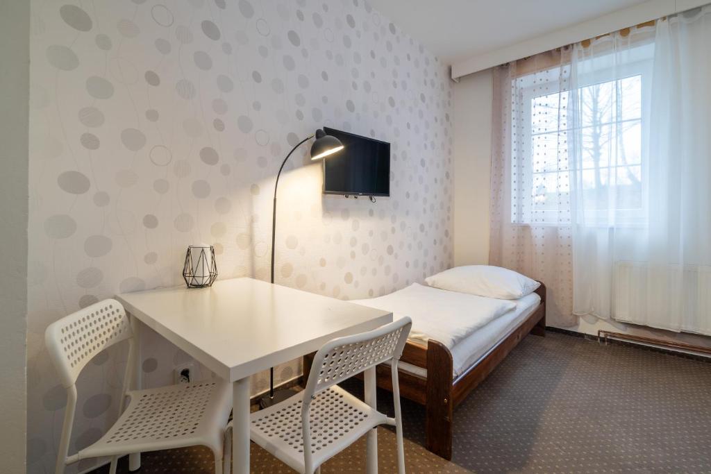 Postel nebo postele na pokoji v ubytování Hotel Garni Orlova