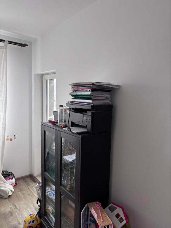 a room with a black book shelf with books at Angels Home Apartment in Bucharest
