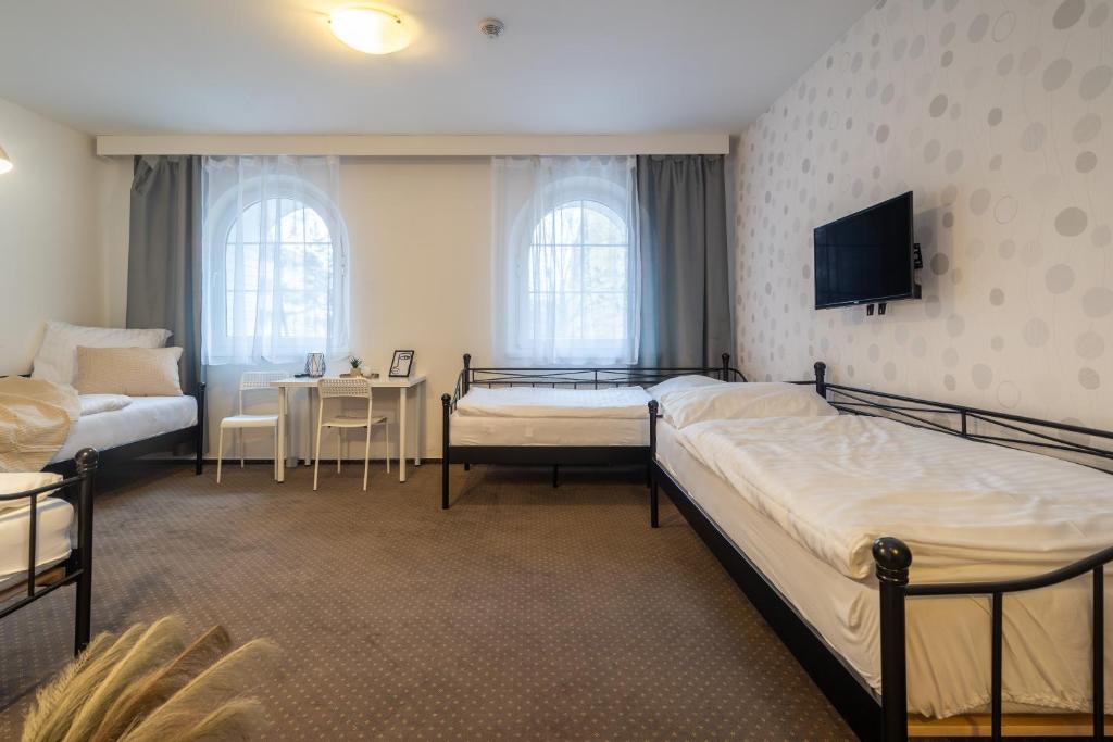 Postel nebo postele na pokoji v ubytování Hotel Garni Orlova