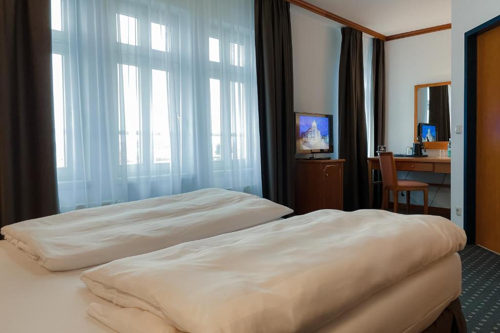 Postel nebo postele na pokoji v ubytování Hotel Alekto