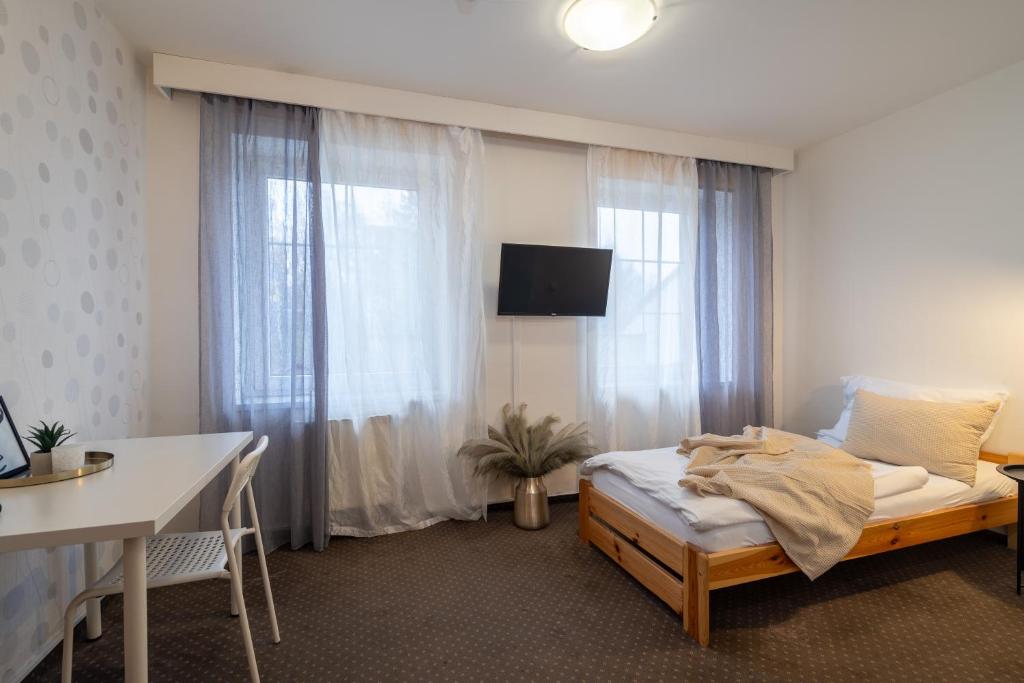 Postel nebo postele na pokoji v ubytování Hotel Garni Orlova