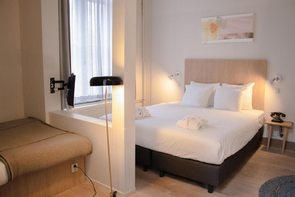 Un ou plusieurs lits dans un hébergement de l'établissement Hotel Arena