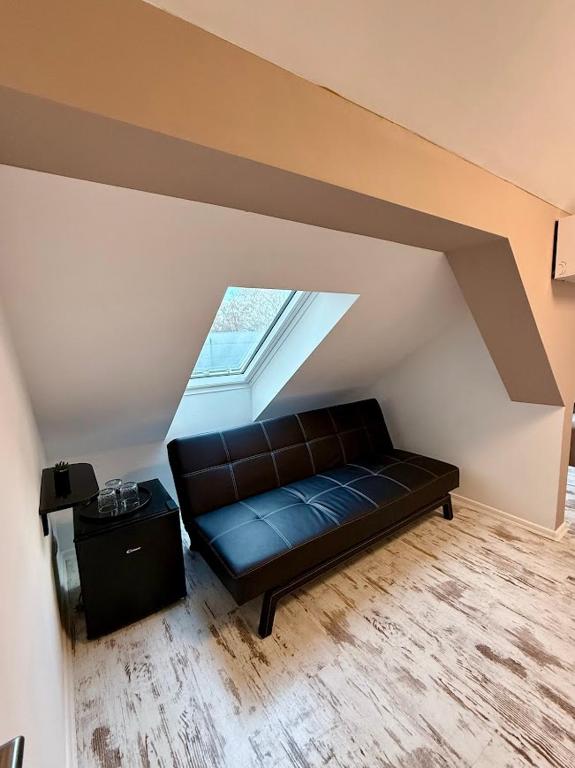 a couch sitting in the middle of a attic at Kuriózum vendégház in Szeged