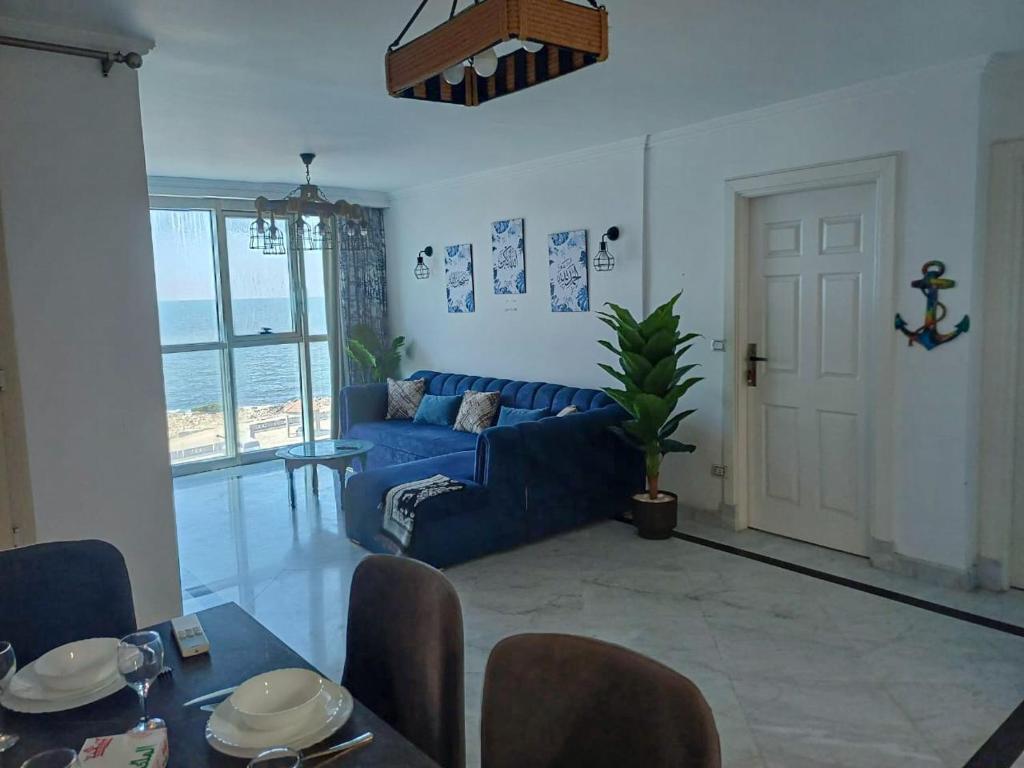 a living room with a blue couch and a table at Skyline Premium Properties in Alexandria