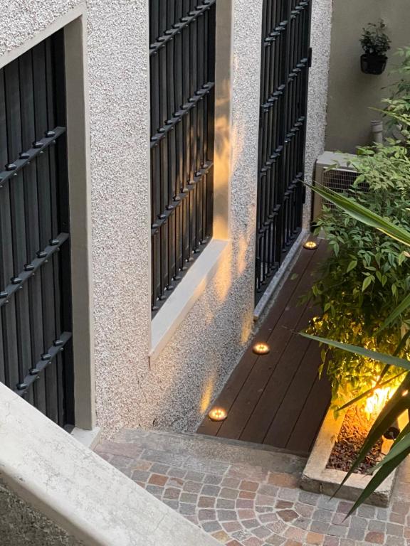 an entrance to a house with a wooden door with lights at Loft 33 in Milan