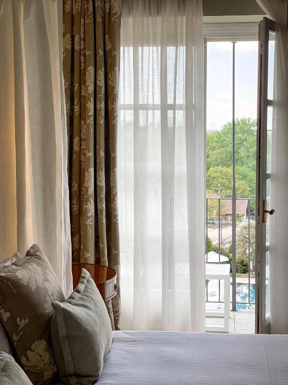 Postel nebo postele na pokoji v ubytování Corte Gondina Boutique Hotel
