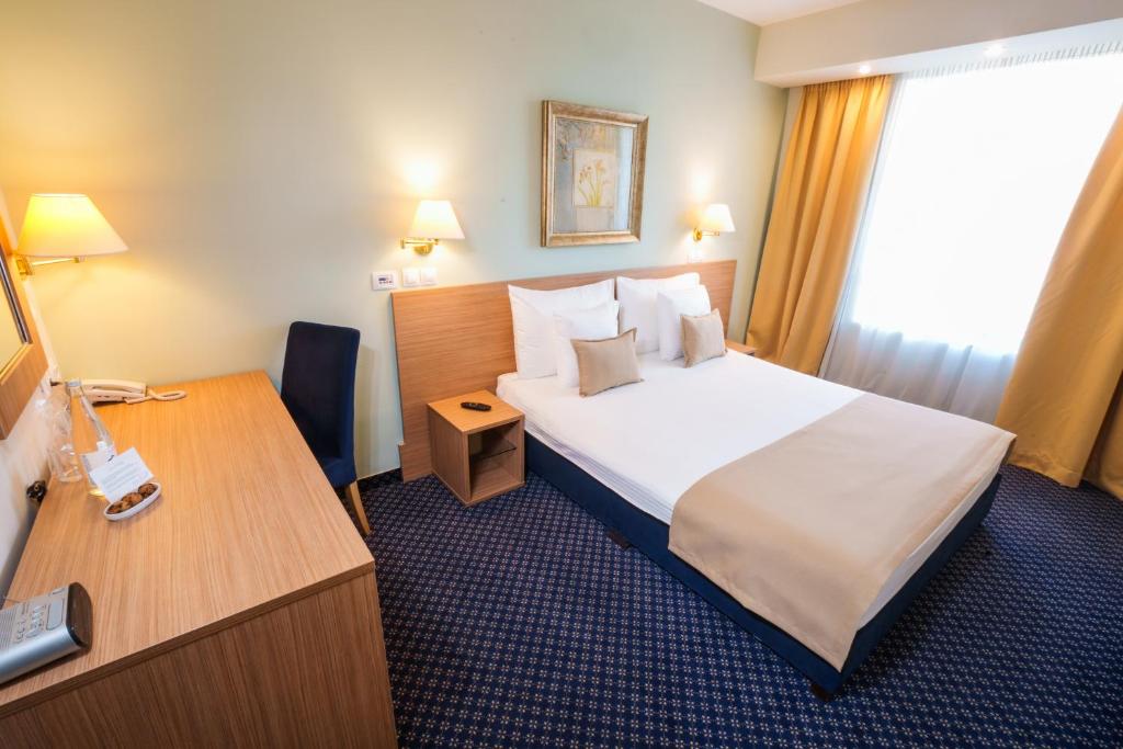 Postel nebo postele na pokoji v ubytování Hotel Monogram Park