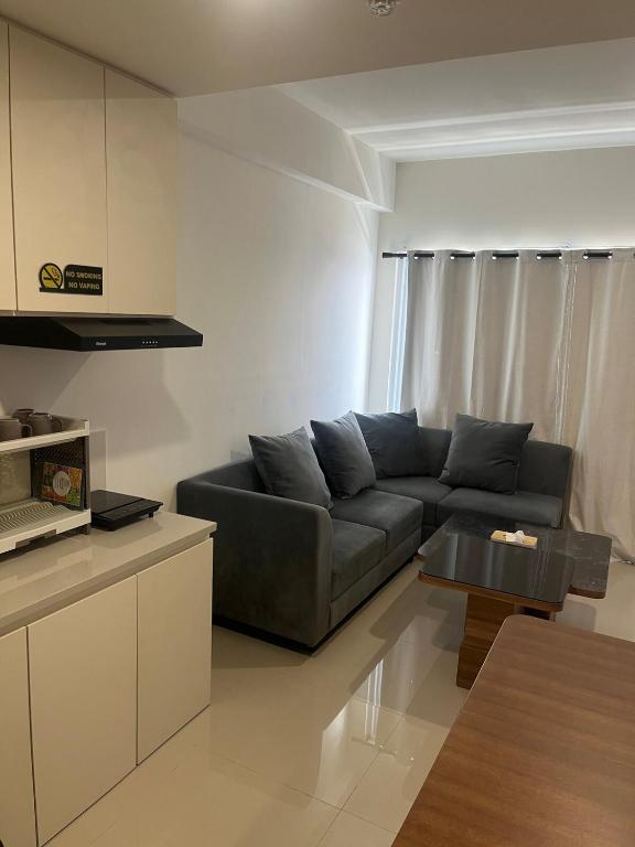 a living room with a couch and a table at Our Home in Jodoh