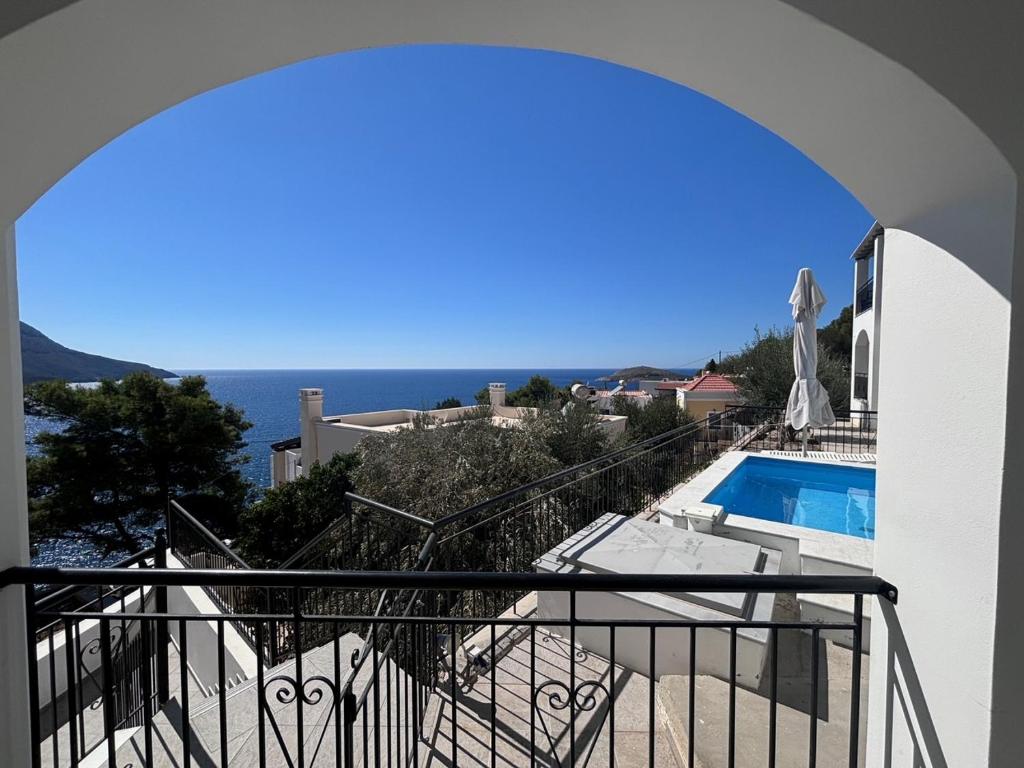 a view from the balcony of a house with a swimming pool at Three Olive Homes in Kalymnos