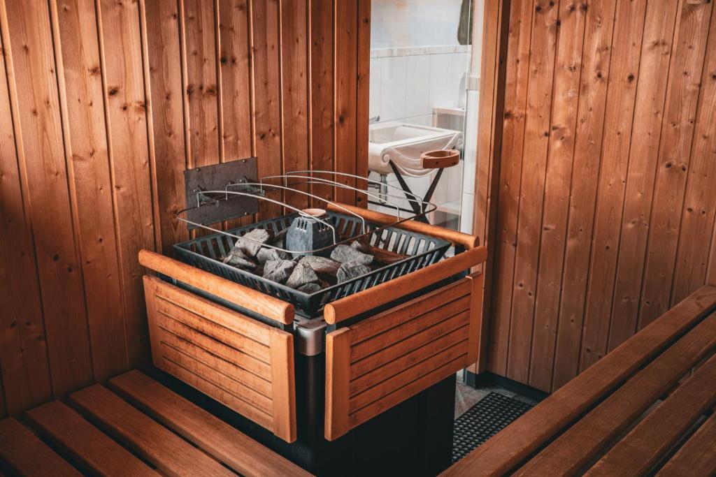 a wooden room with a chest of logs in a room at Hotel Goldener Greif in Kitzbühel