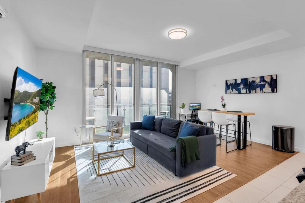 a living room with a couch and a table at Sleek 1BR Near BOKCenter-Gym,Lounge,Balcony,PetOK in Tulsa