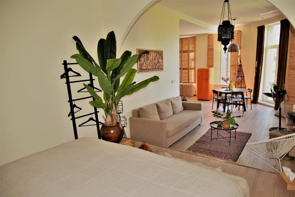 a bedroom with a bed and a living room at SLEEP INN ANTWERP - Flats & Suites in Antwerp