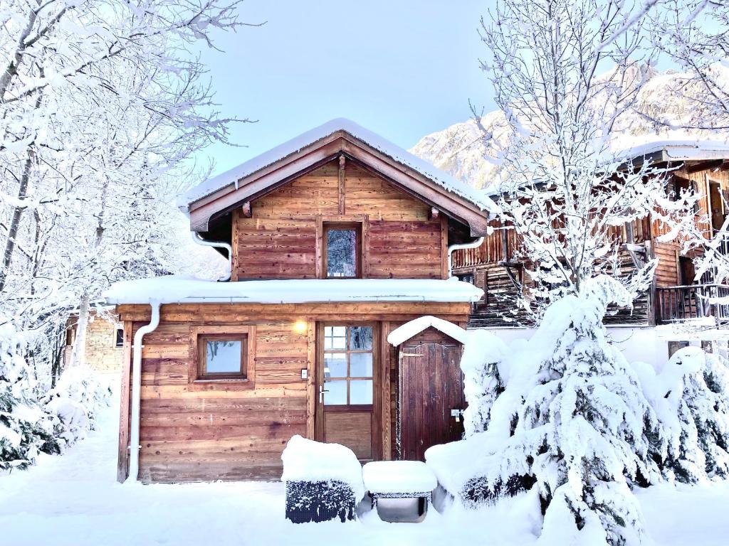a log cabin in the snow with snow covered trees at Gorgeous Mini-Chalet Chamonix in Chamonix-Mont-Blanc
