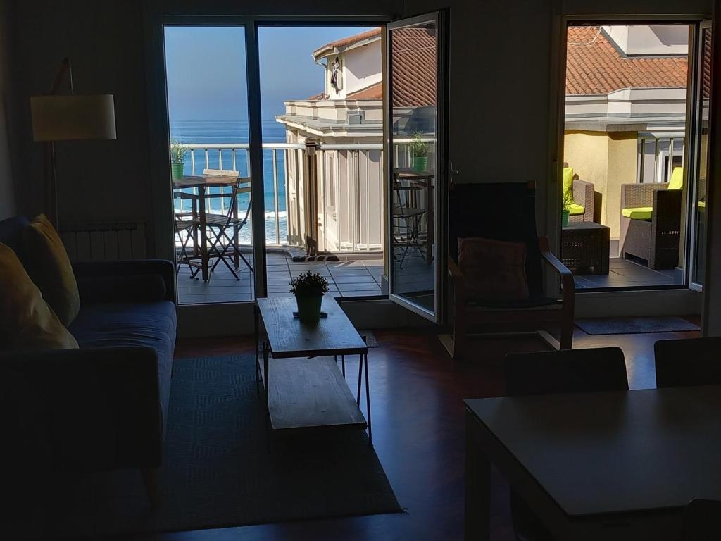 a living room with a couch and a table at Attic+views+terrace+parking in Donostia-San Sebastián