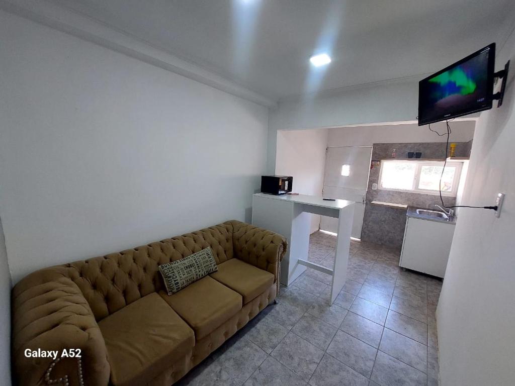 a living room with a couch and a table and a television at Santa Lucia in Necochea
