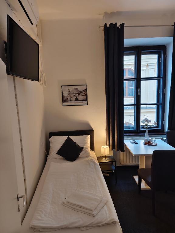 Postel nebo postele na pokoji v ubytování Hotel Bílý Koníček