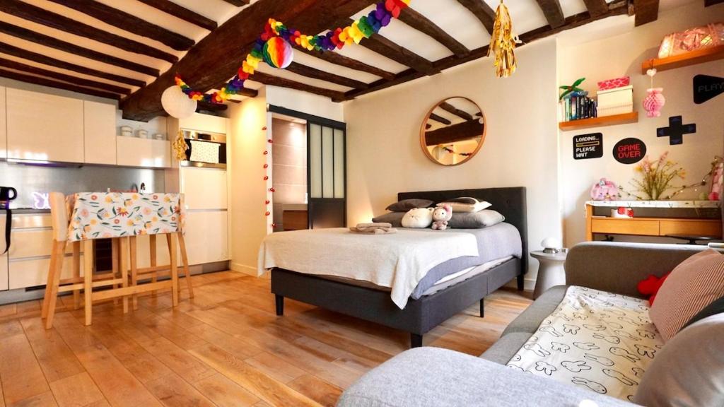 - une chambre avec un lit dans une pièce avec une cuisine dans l'établissement 01 Grand studio at Rambuteau, à Paris