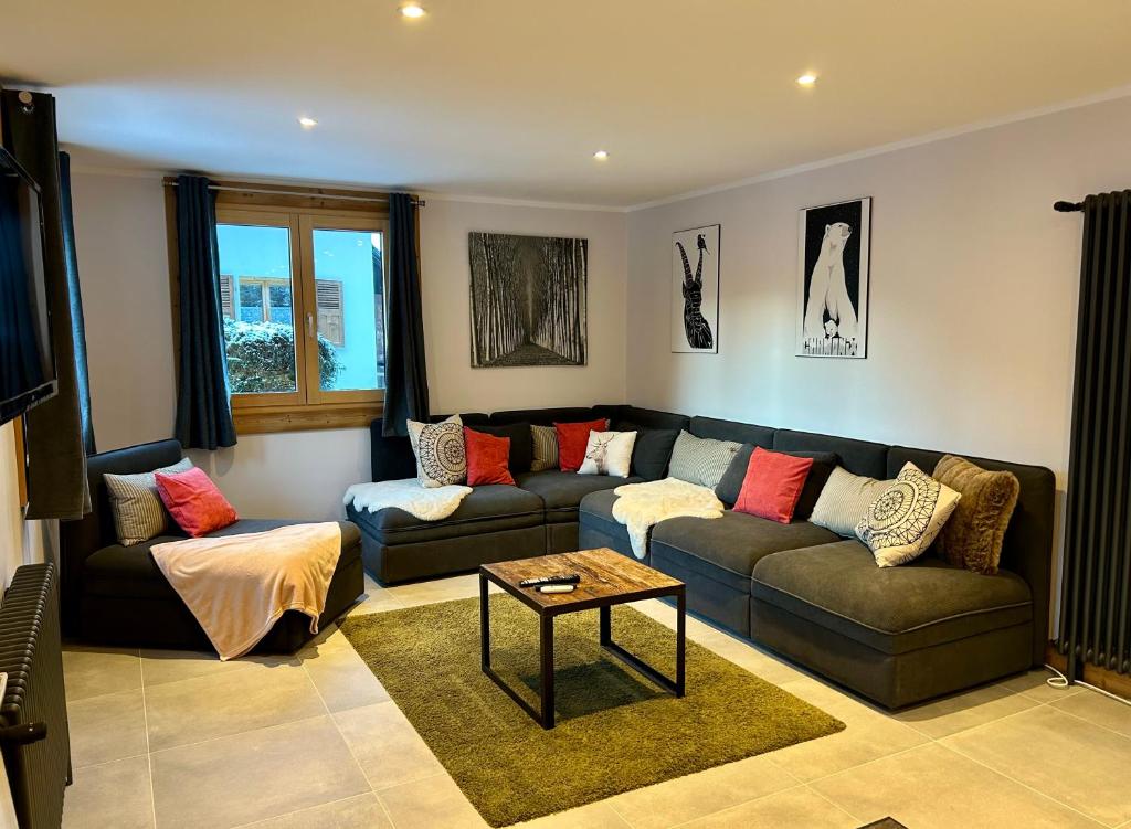 a living room with a couch and a table at 4 Bedroom, 4 Bathroom, Hot Tub, Chamonix Centre in Chamonix-Mont-Blanc