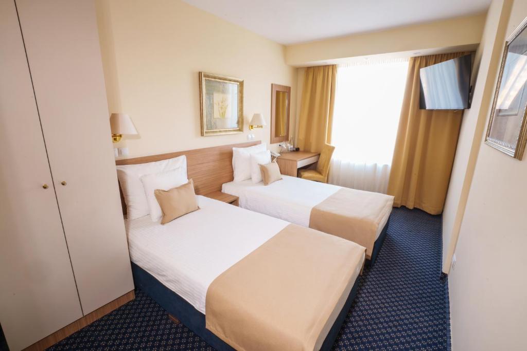 Postel nebo postele na pokoji v ubytování Hotel Monogram Park