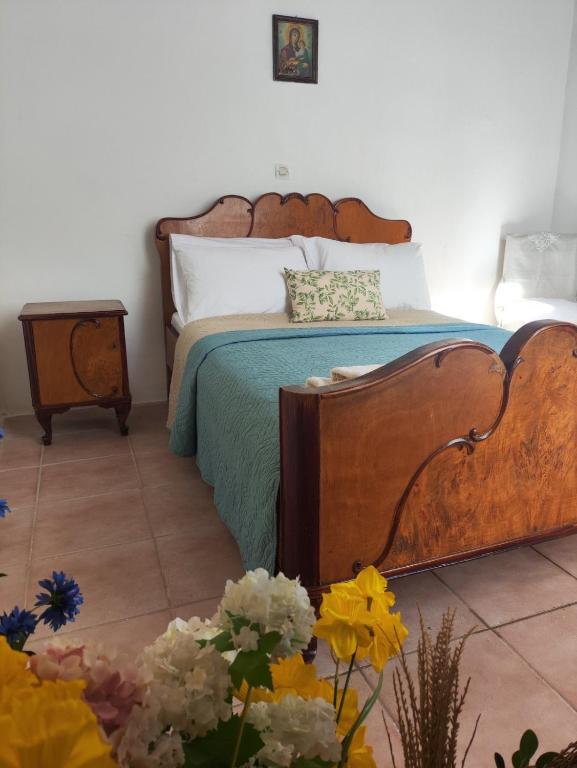 a bedroom with a bed and flowers on the floor at Casa Violeta by 8essentially in Kefalás