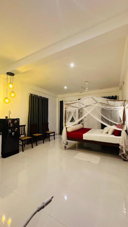 a bedroom with a bed and a living room at Villa J Ambalangoda in Ambalangoda