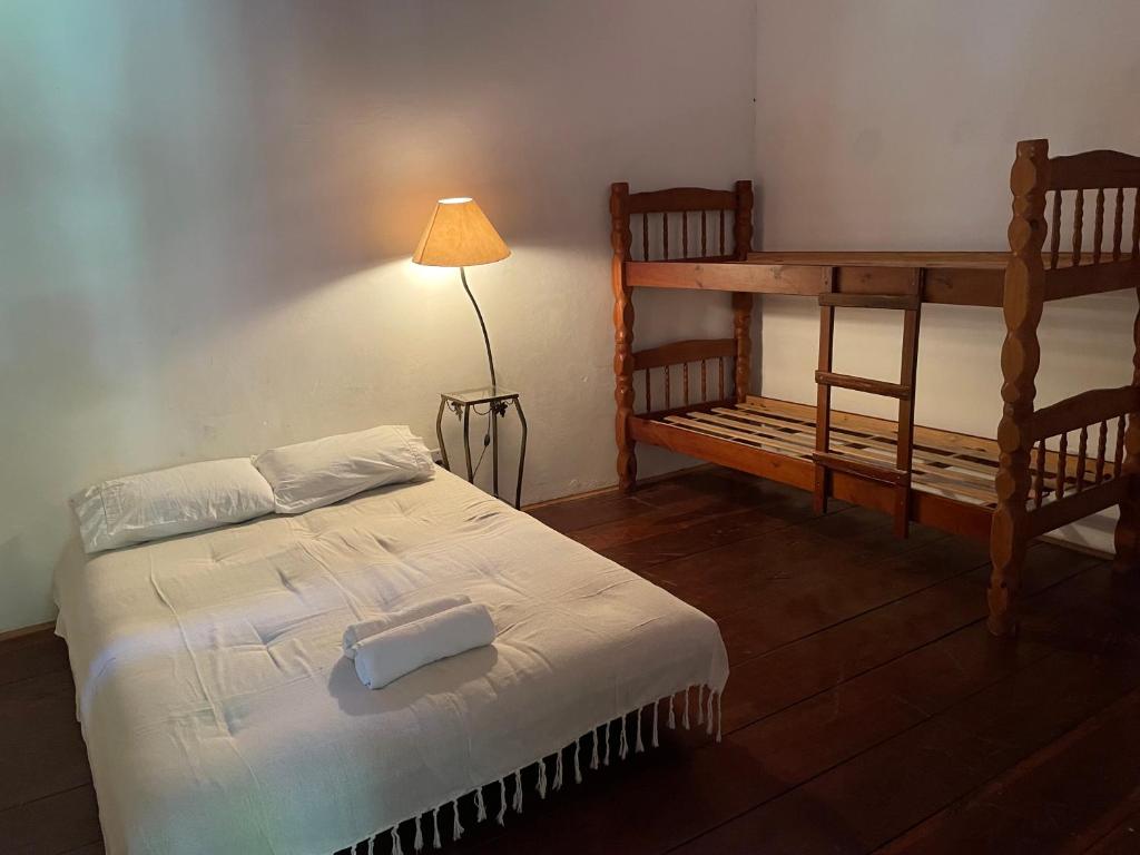 a bedroom with a bunk bed and a lamp at Pouso in Paraty