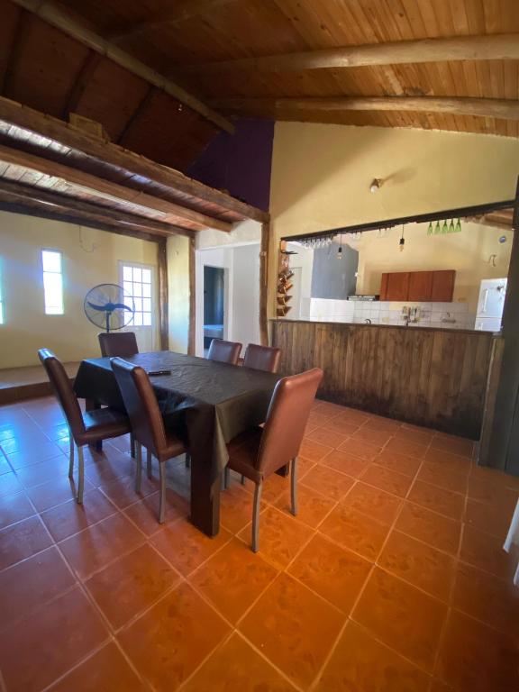a dining room with a black table and chairs at casa cepeda in Colón