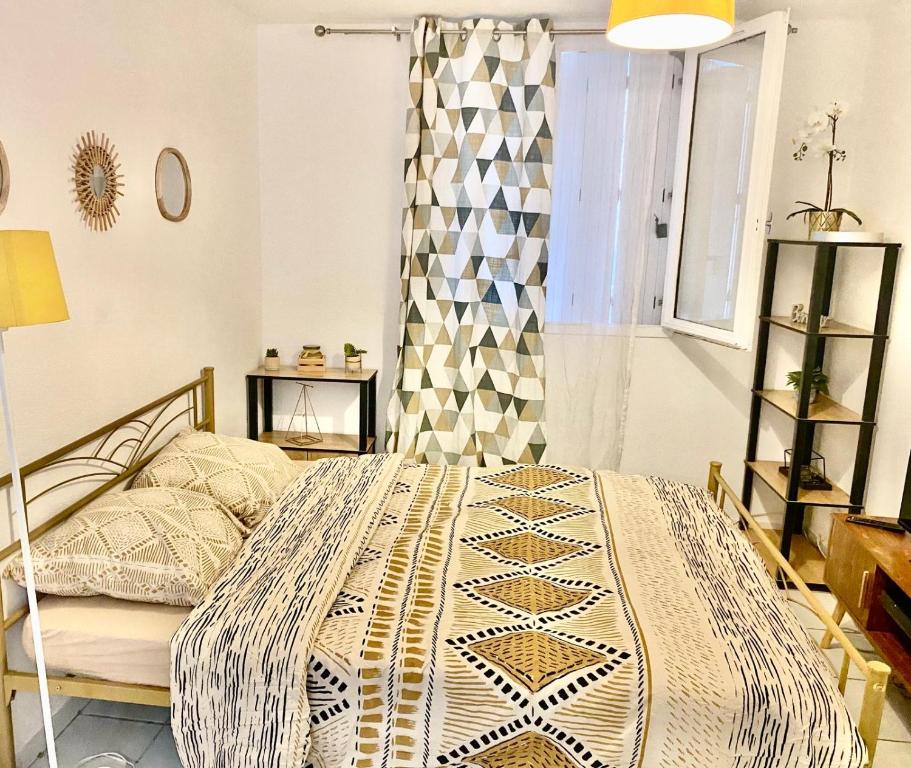 une chambre avec un lit et une fenêtre dans l'établissement Studio à 5 mn à pied de la gare Saint-Roch, à Montpellier