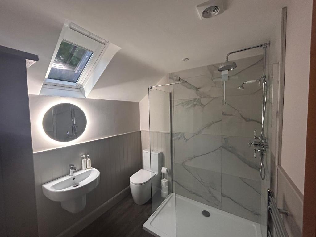 a bathroom with a shower and a sink and a toilet at Aldernaig Mill in Invergarry