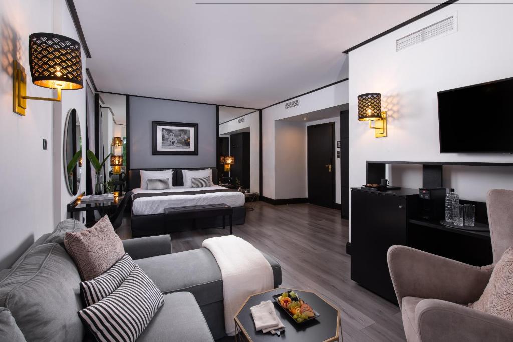 a hotel room with a bed and a couch at Athenian Riviera Hotel& Suites in Athens